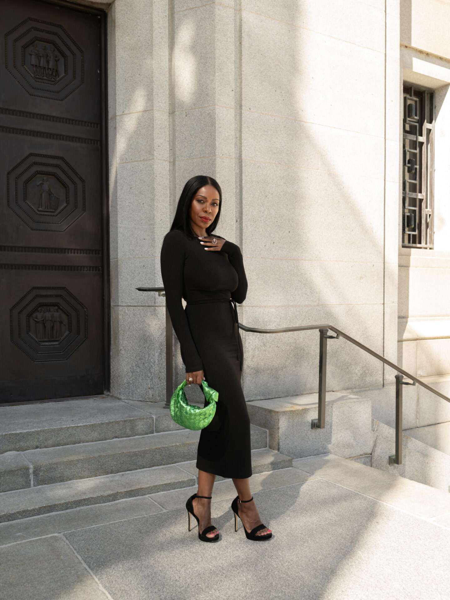 Dominique Baker Standing at the Supreme Court of Justice Holding Bottega Veneta Jodie Bag